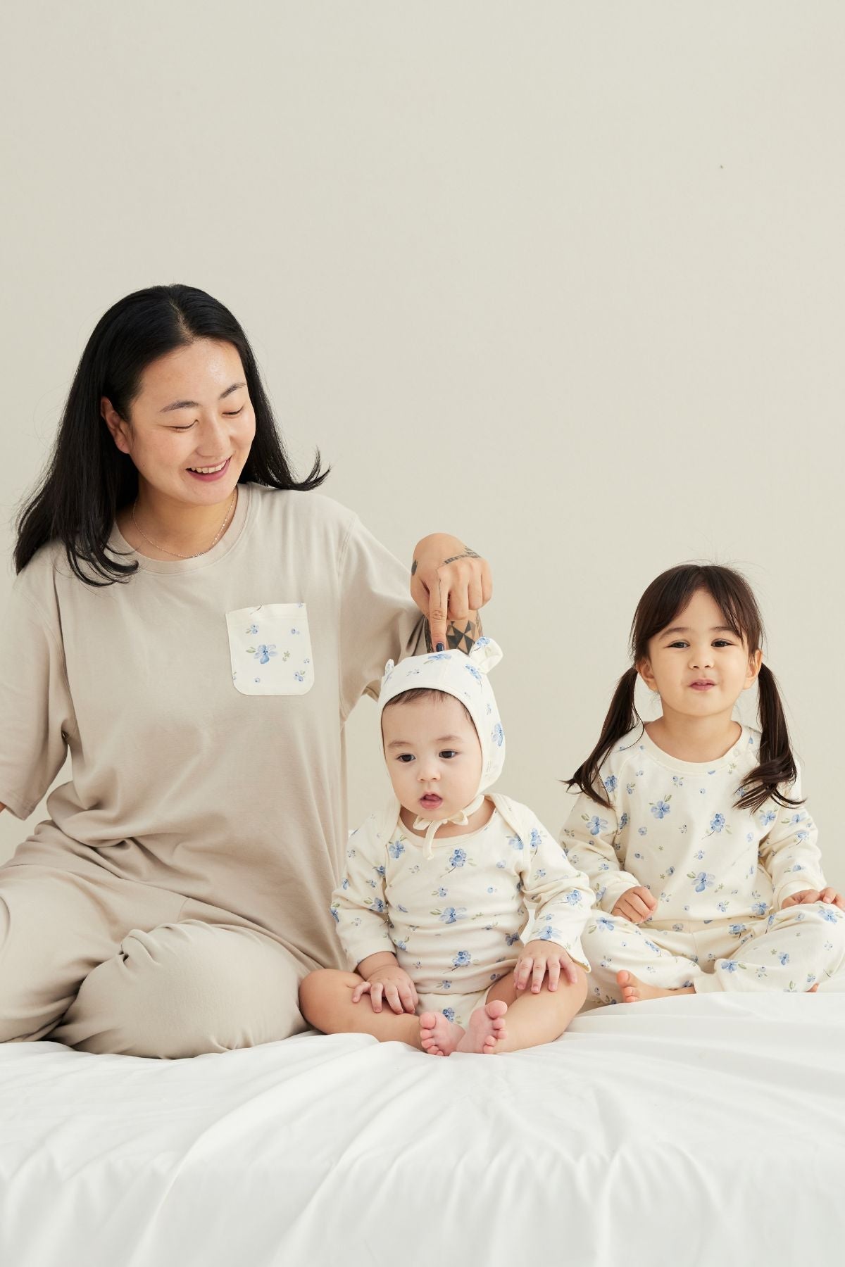 mom wearing blueberry pajama, baby boy wearing blueberry onesie, baby girl wearing blueberry pajama