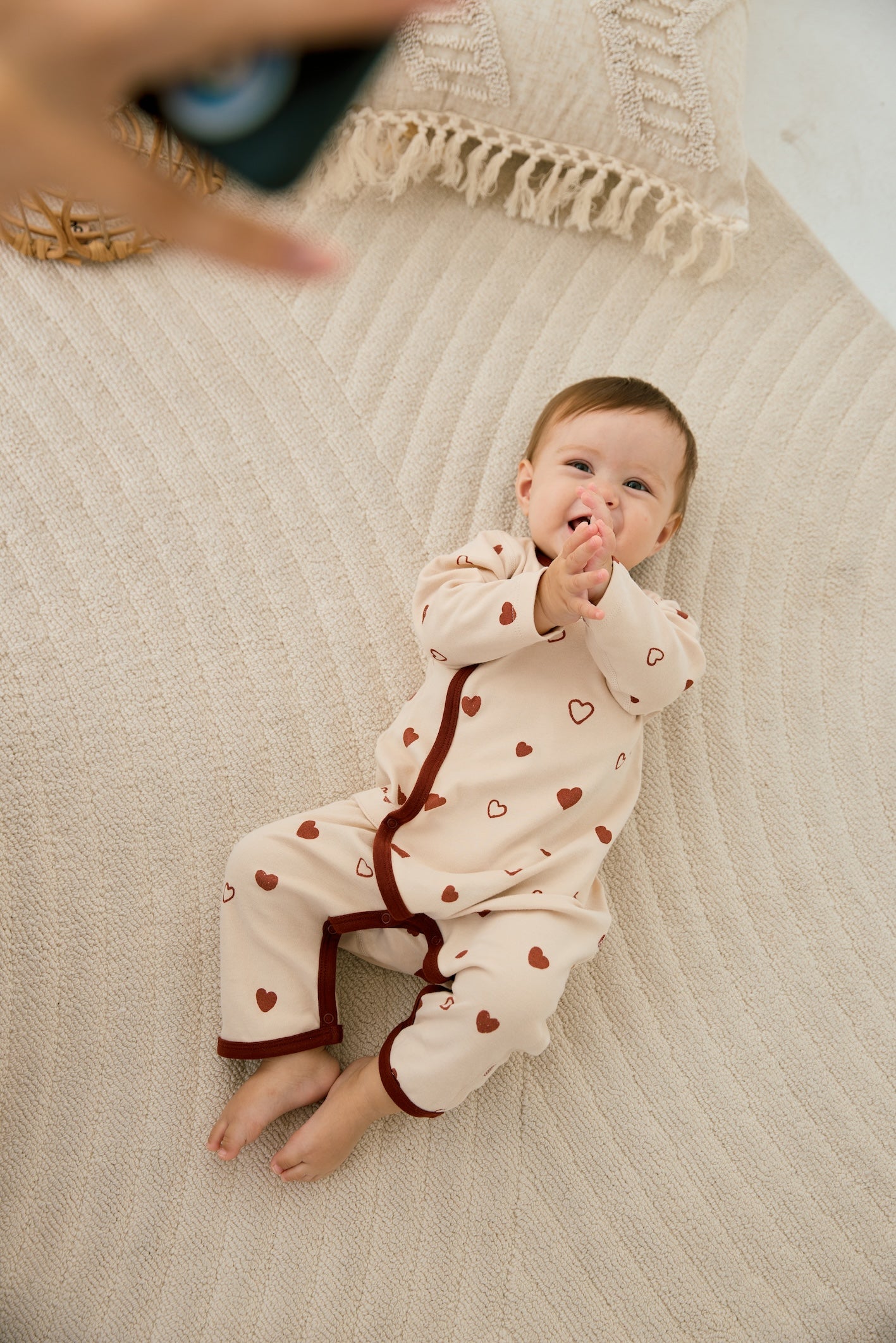 Baby girl laying on the floor and smilling to the camare