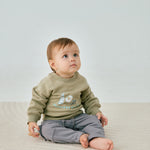 baby sitting and wearing Toddler Organic Fleece Sweatshirt-Milky