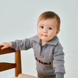 baby standing beside chair and wearing Toddler Organic Fleece Zip-up Sweatshirt-Dreams