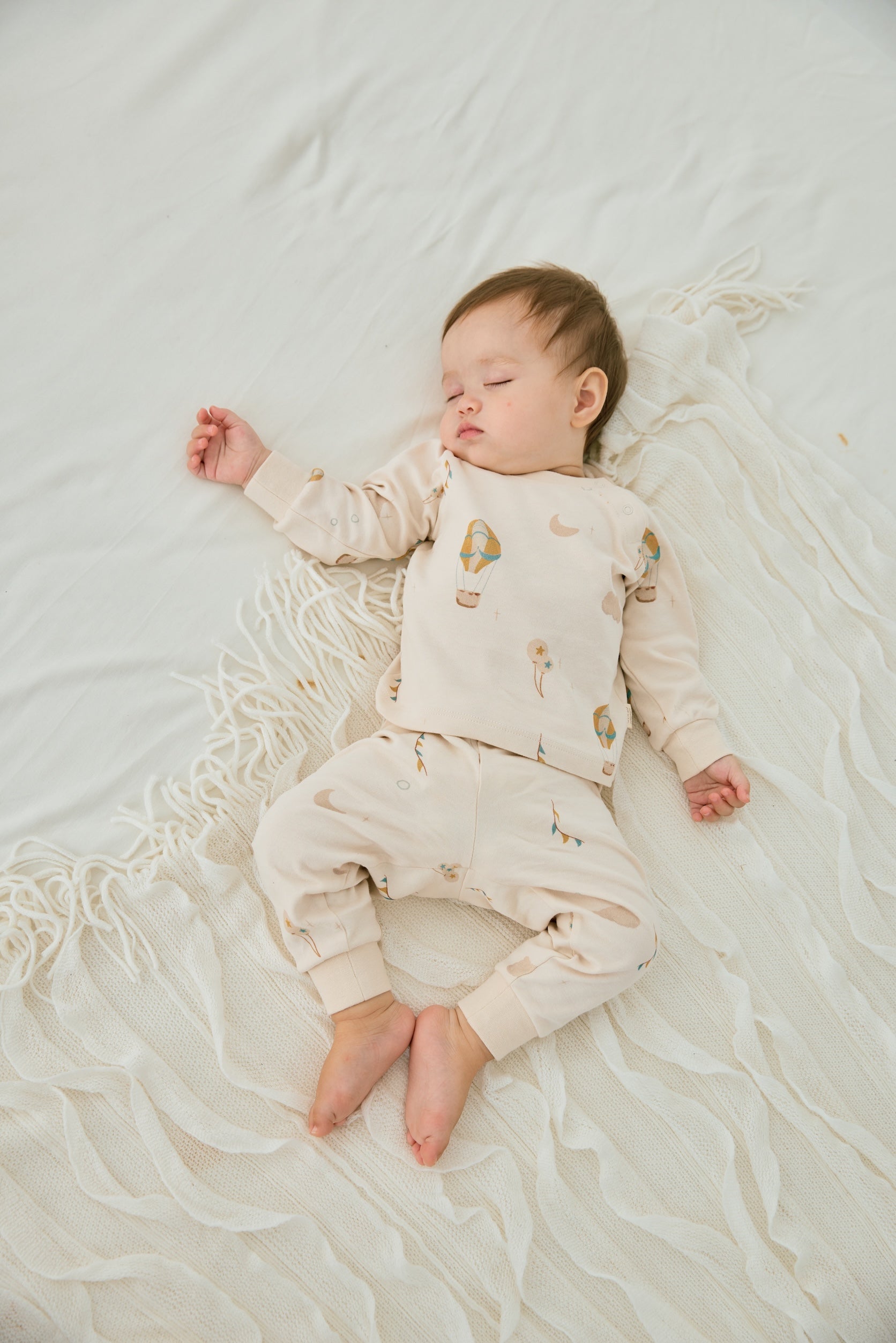 baby sleeping and wearing Organic Toddler Pajama Set-Fantasy