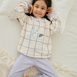 baby girl lying on the bed and wearing Organic Toddler Pajama Set-Milky