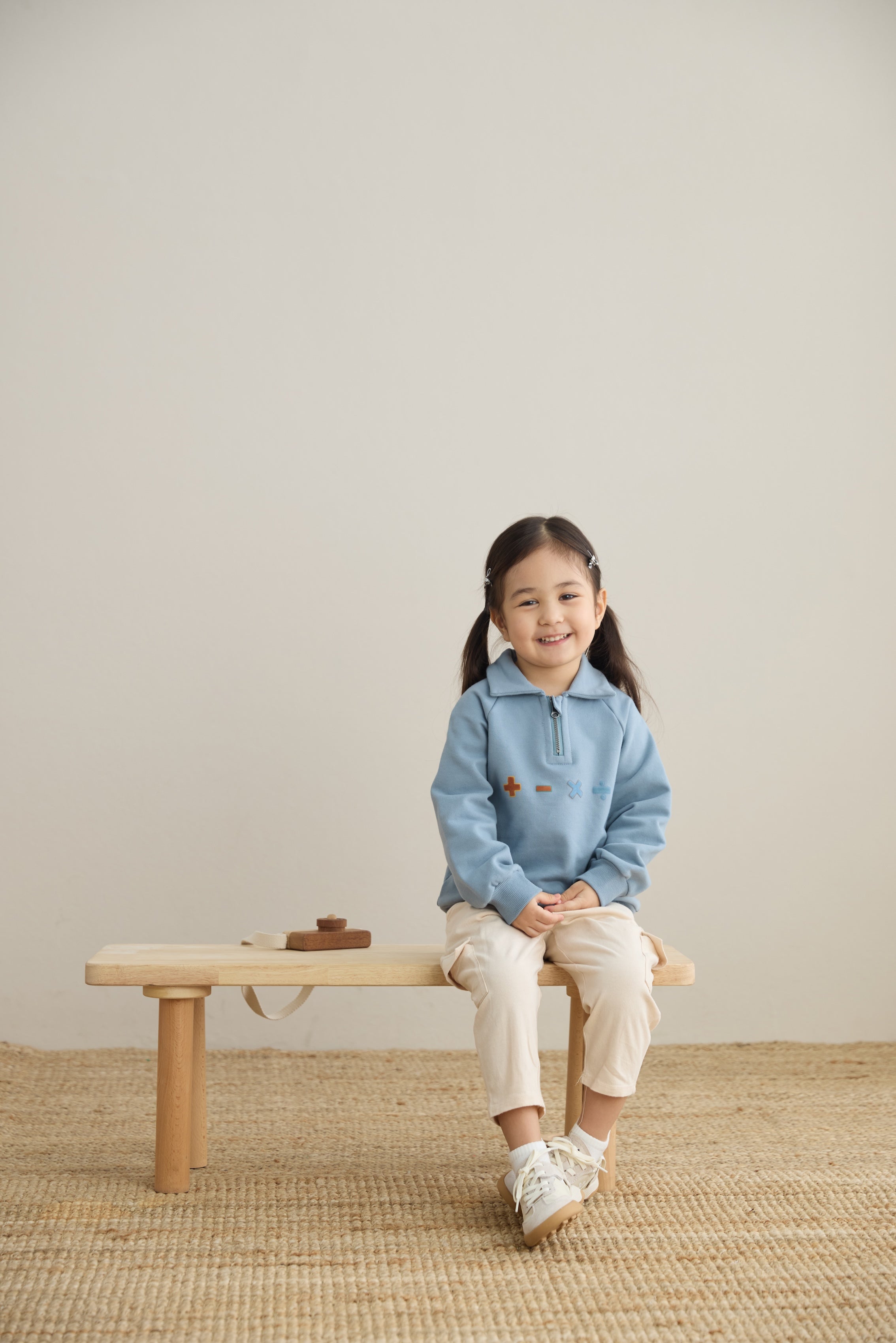 baby sitting on the chair and wearing Toddler Organic Fleece Zip-up Sweatshirt-Symbols