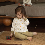 model sit and wearing Organic Toddler Pajama Set-Pear Garden