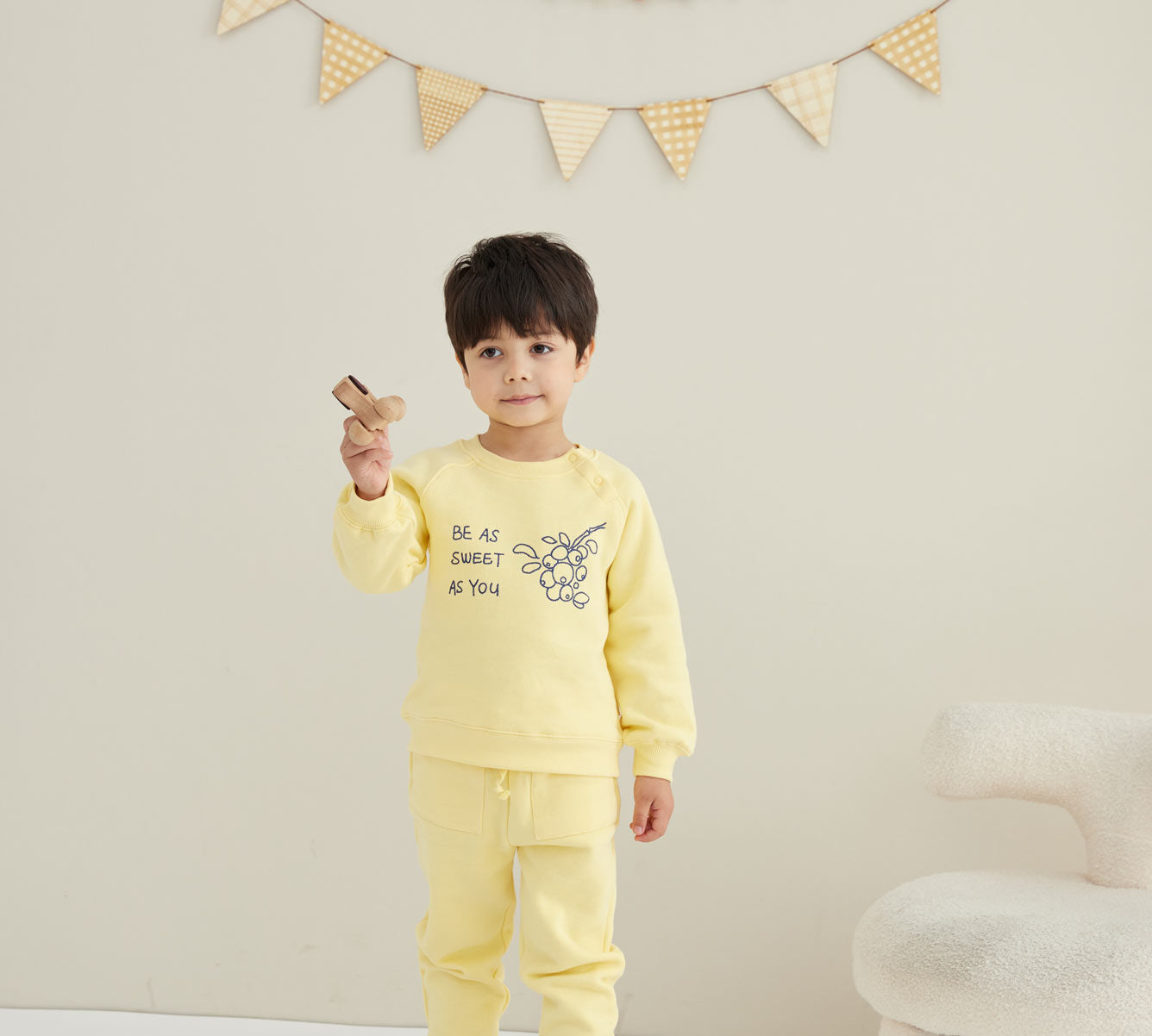 model wearing Toddler Organic Fleece Sweatshirt-Mellow Yellow with paring pants