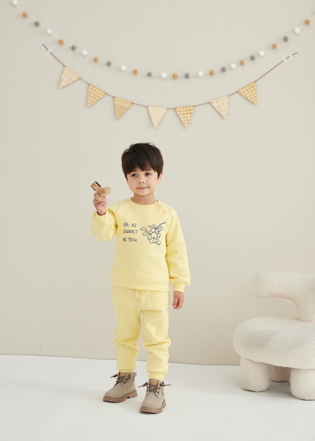 model wearing Toddler Organic Fleece Sweatshirt-Mellow Yellow with paring pants