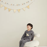 model sitting and wearing Toddler Organic Fleece Sweatshirt-Dark Grey
