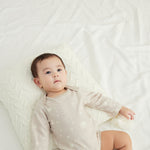 Baby laying down and wearing Baby Organic Long-sleeve Onesie-Stary