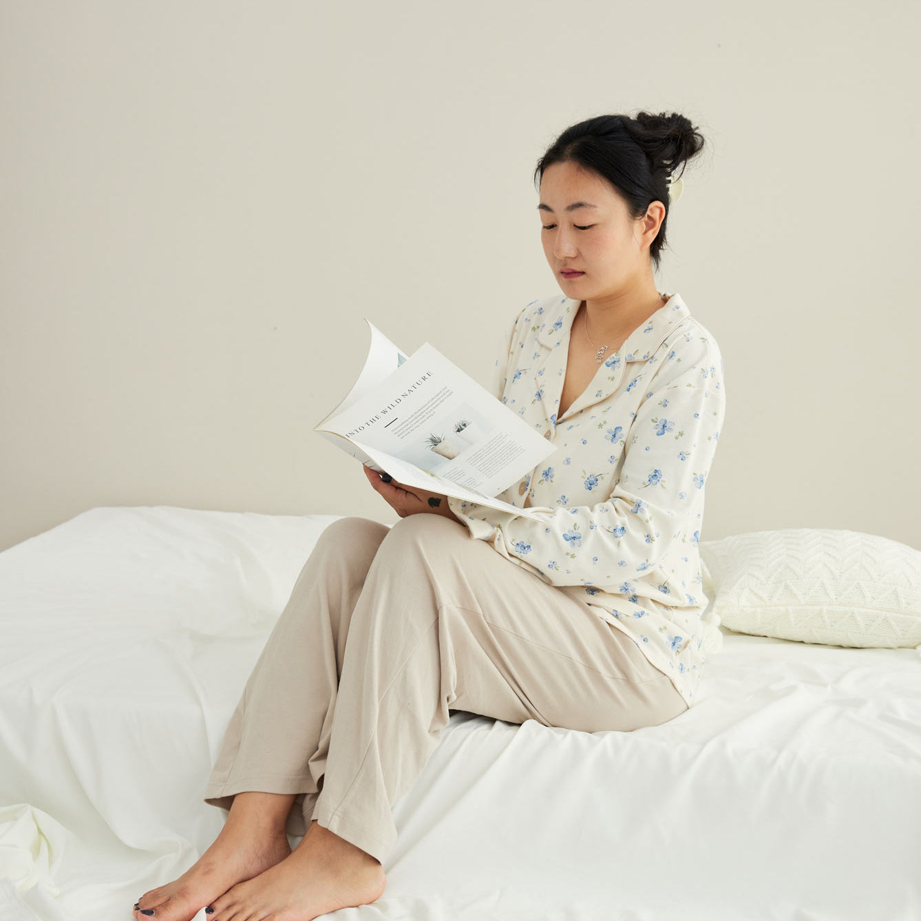 model reading book and wearing Women Organic Long-sleeve PJ Set-Blueberry
