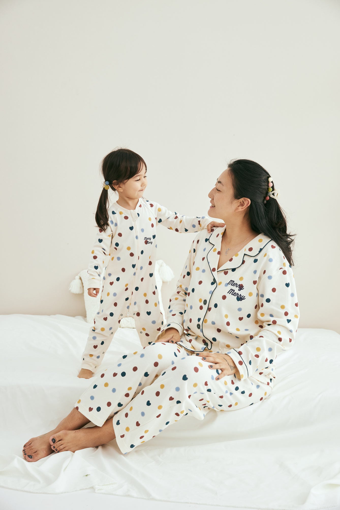 Model weraing merry dot pajama with her daughter