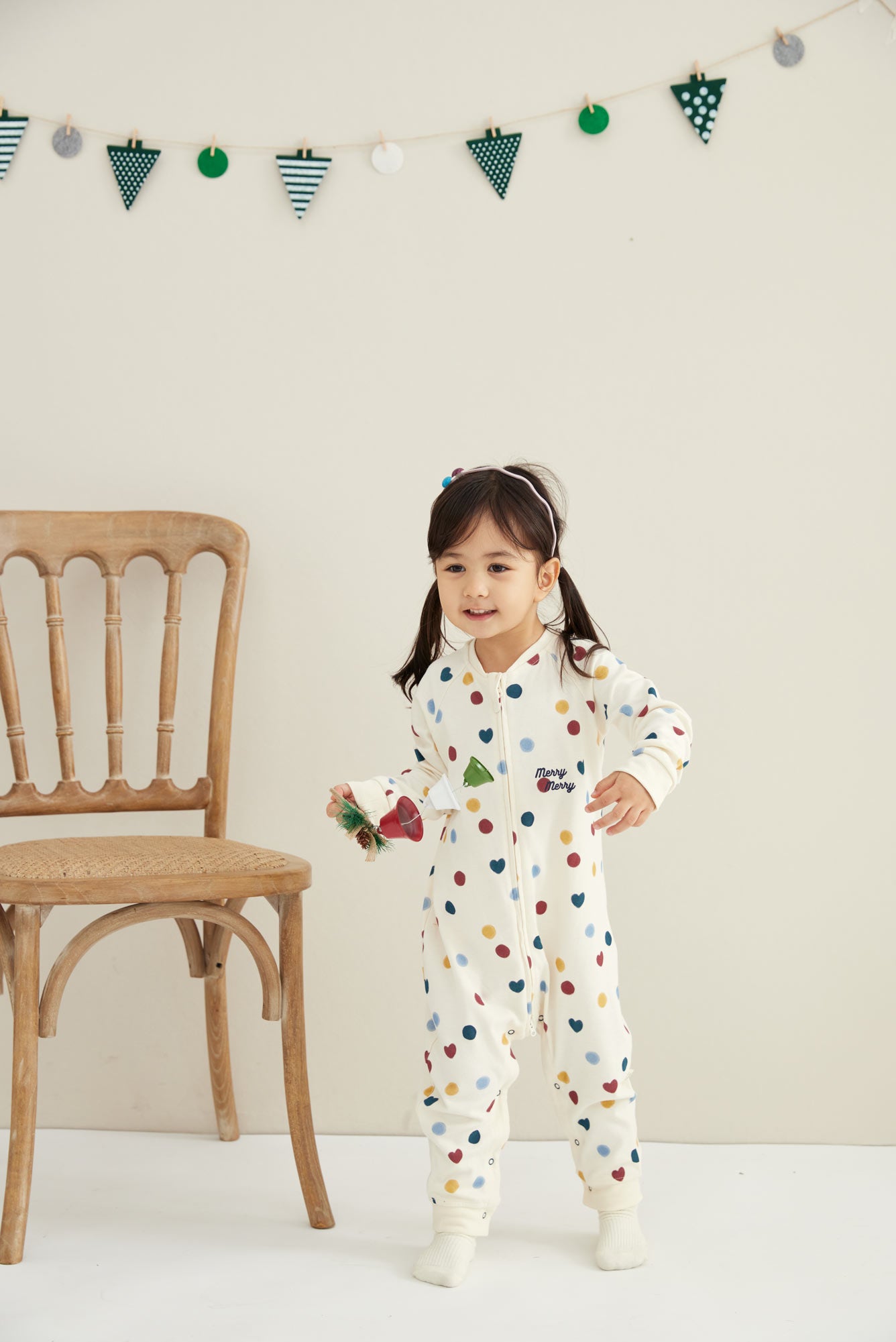 Model wearing Baby Organic Cotton Zip-up Sleeper-Merry Dots