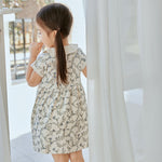 baby girl stand in front of the window and watching outside