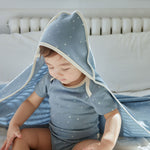 baby boy is wearing Baby Organic Short-Sleeve Onesie-Blue Starry and wearing blanket as well