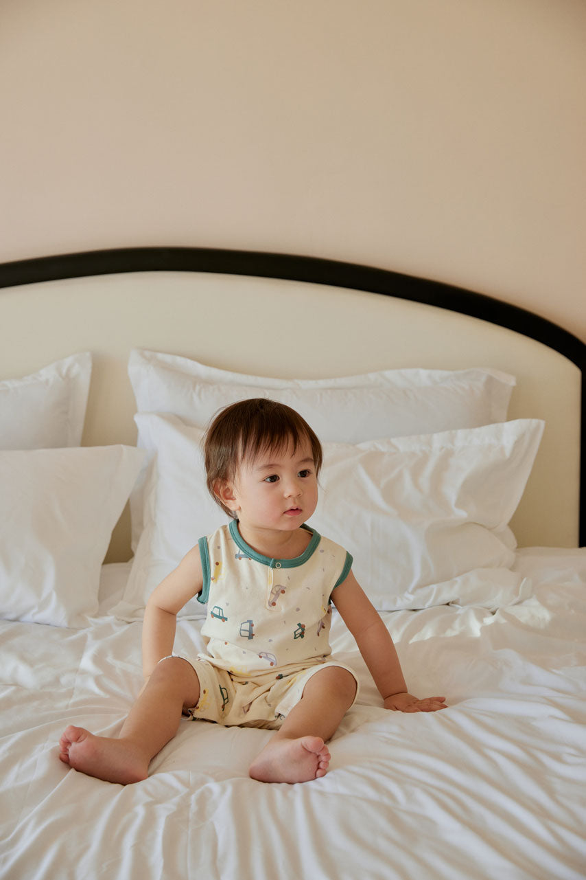 baby sititng on the bed and wearing Baby Organic Cotton Tank Romper-Cars