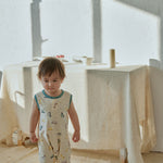baby standing on a carpet and wearing Baby Organic Cotton Tank Romper-Cars