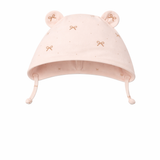 Pink baby hat with bear ears and bow details on a white background