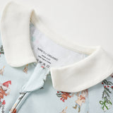 Close-up of a baby outfit with jolly pattern and white collar, featuring a visible brand label.