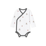 White baby onesie with penguin pattern on a white background