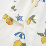 Close-up of a fabric with lemon and umbrella pattern on a white background