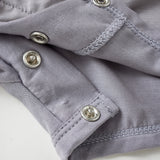 Close-up of a gray fabric with buttons on a white background