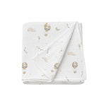 Folded baby blanket with hot air balloon pattern on a white background