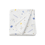 Folded baby blanket with space-themed pattern and 'Lunaris' branding on a white background