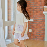girl in white pocket shirt standing on the floor