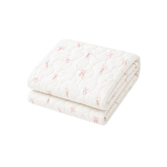 Folded quilt with a cute pattern on a white background