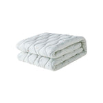 Folded light space partten blanket on a white background