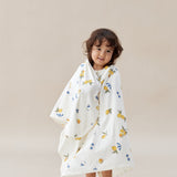 Child wearing a floral patterned baby wrap against a plain background