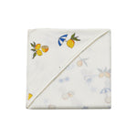 Folded towel with fruit pattern on a white background