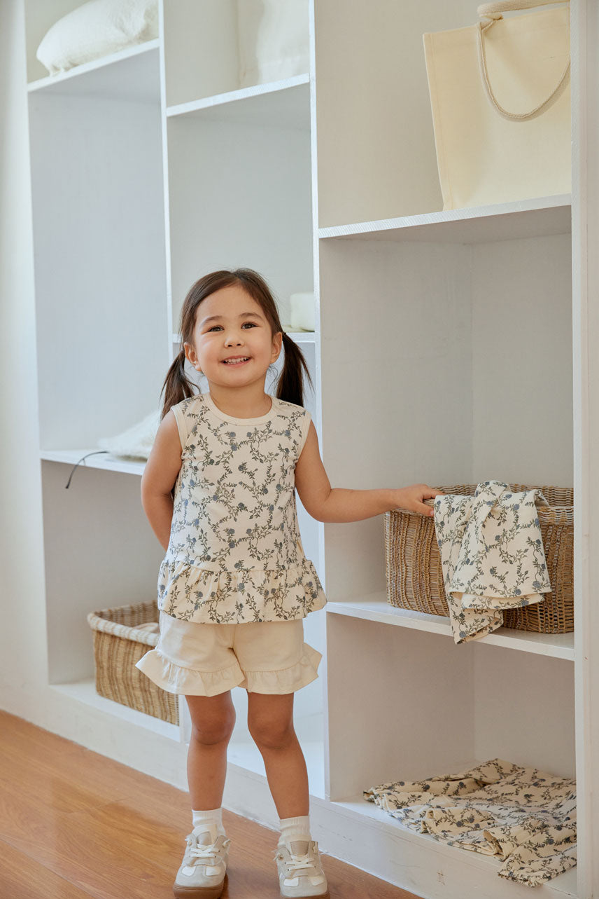 baby is holing a basket beside the closet 