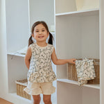 baby is holing a basket beside the closet 