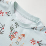 Baby pajama with Christmas-themed print on a light blue background
