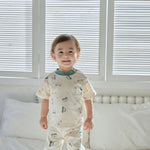 baby boy standing on the bed