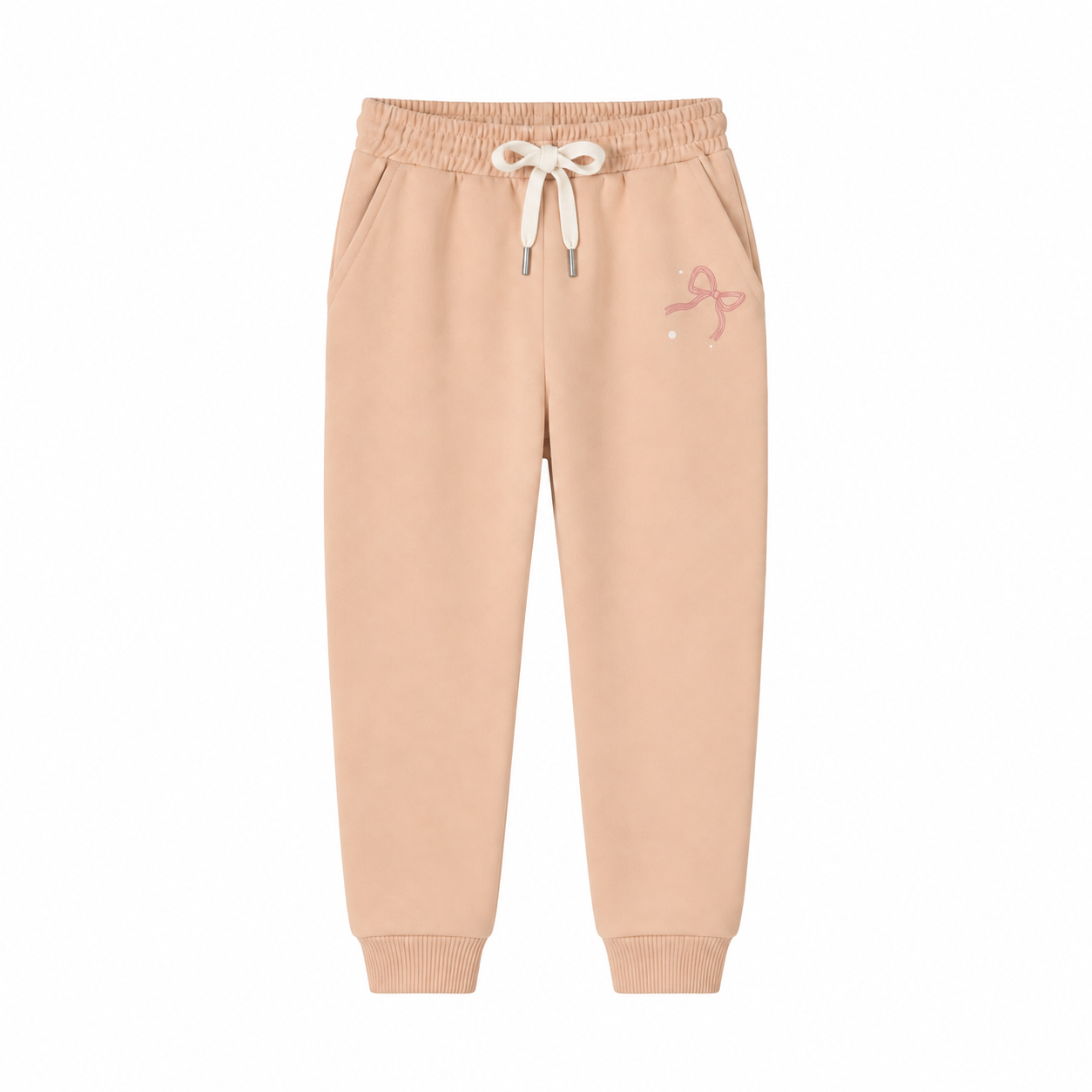 A pair of light peach-beige jogger sweatpants with an elastic waistband, white drawstring, and a small pink bow graphic on the left thigh, shown against a plain white background.