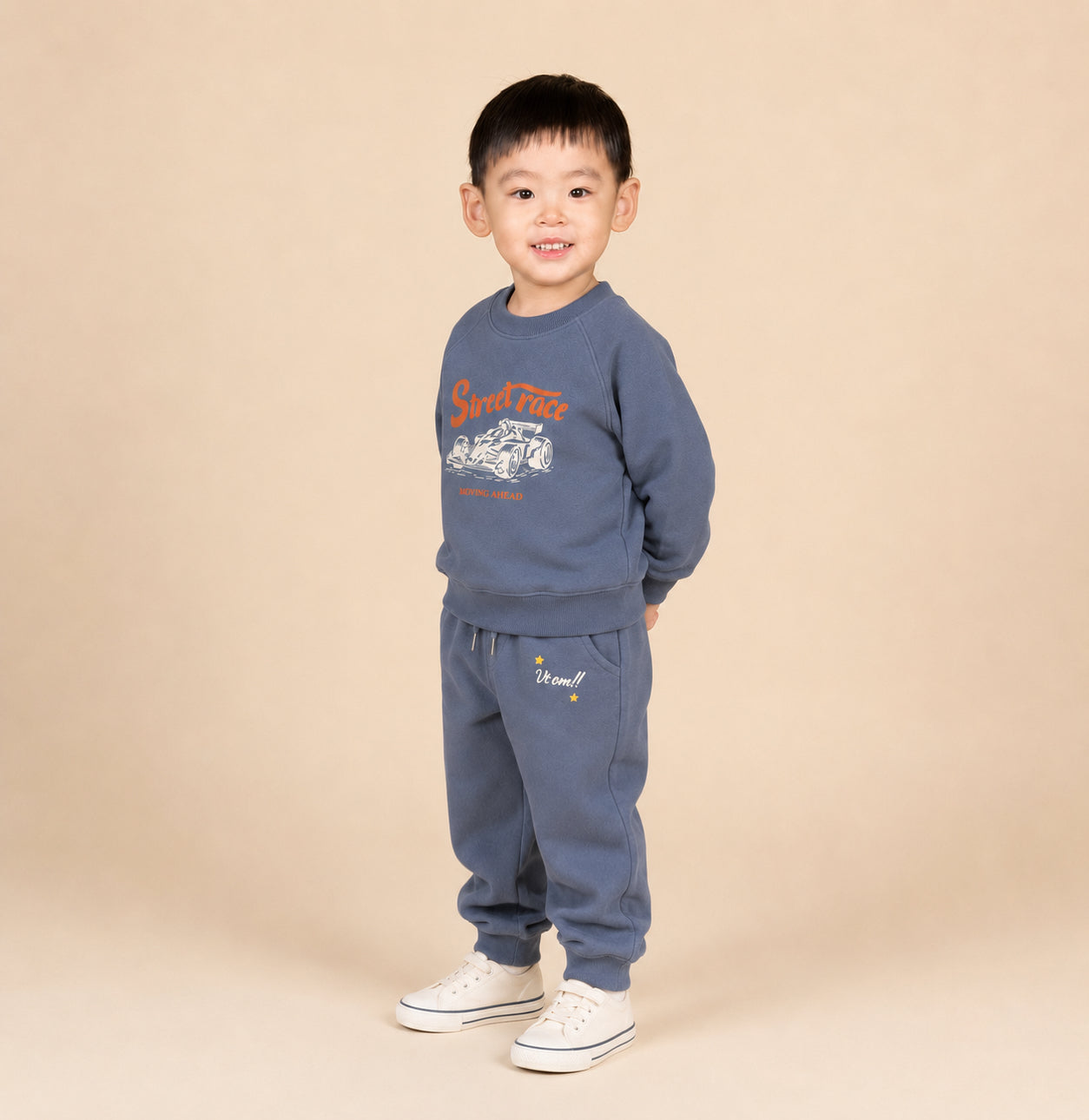 Child wearing a blue sweatshirt and pants set with text on a beige background