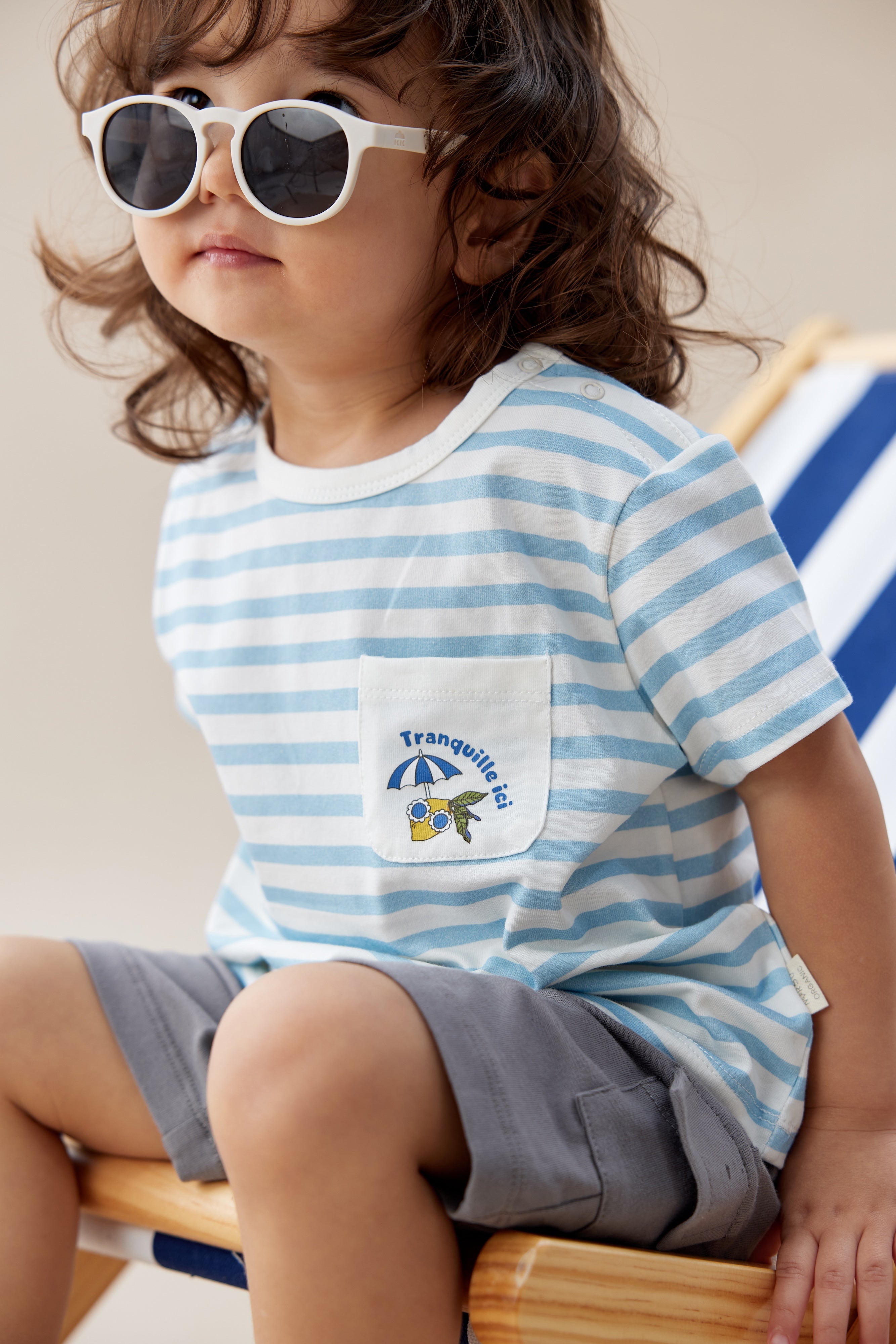 Toddler wearing a light blue organic graphic t-shirt in summer