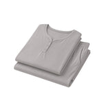 Folded gray shirt and pants set on a white background