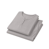 Folded gray shirt and pants set on a white background