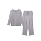 A two-piece light gray loungewear set consisting of a long-sleeve henley-style top and matching straight-leg pants, displayed on a solid white background.