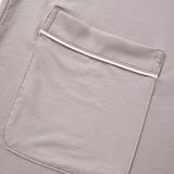 Close-up of a pocket on a gray garment with a zipper.