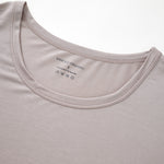 Close-up of a light gray t-shirt with a brand label on the collar.