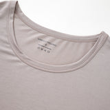 Close-up of a light gray t-shirt with a brand label on the collar.