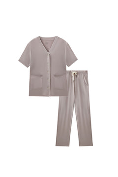 Light gray scrub set with top and pants on a white background