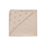 Beige blanket with small red patterns on a white background