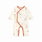 A baby long-sleeve sleep sack or romper in cream with a scattered acorn print and orange trim, shown flat on a white background.