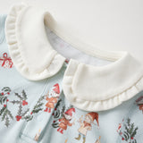 White ruffled collar on a light blue shirt with Christmas-themed design