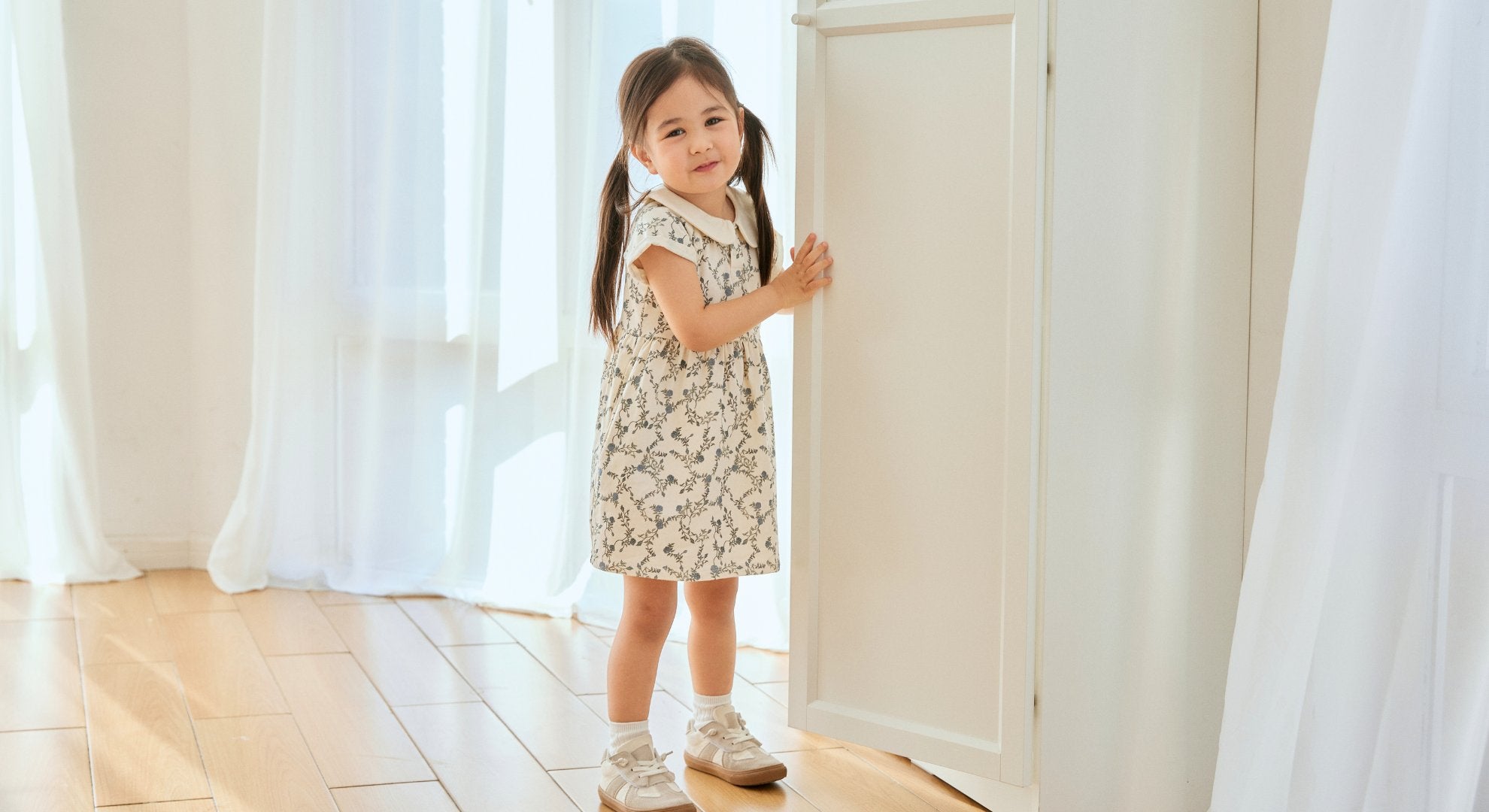 girl stand behind the door and smiling