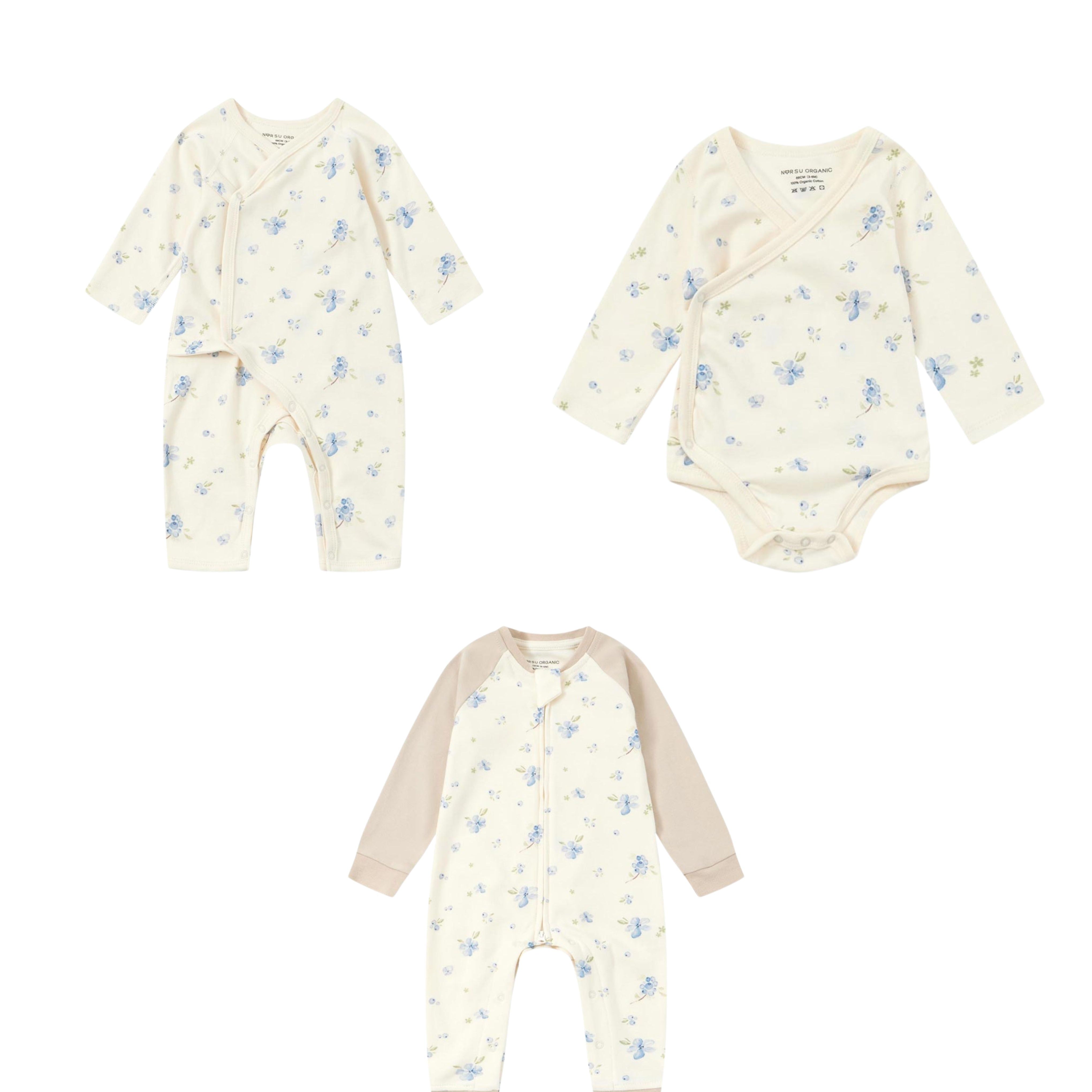 Baby clothing set with onesie, romper, and bodysuits on a white background